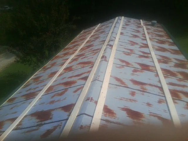 Rusted metal roof panels with new wood purlins before replacement — Storm Damage Roof Repair in Lovelock by Roofing Brothers